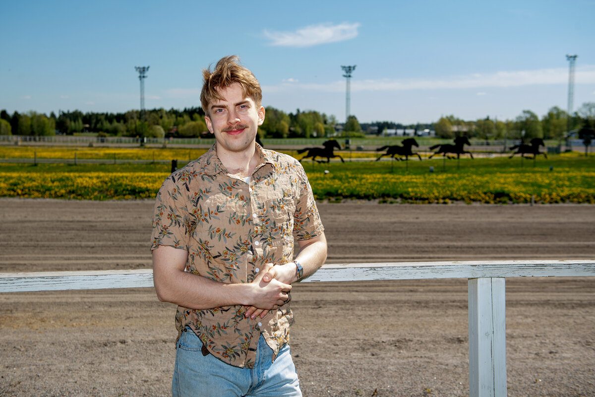 Onni Lampikoski standing outdoors by a field